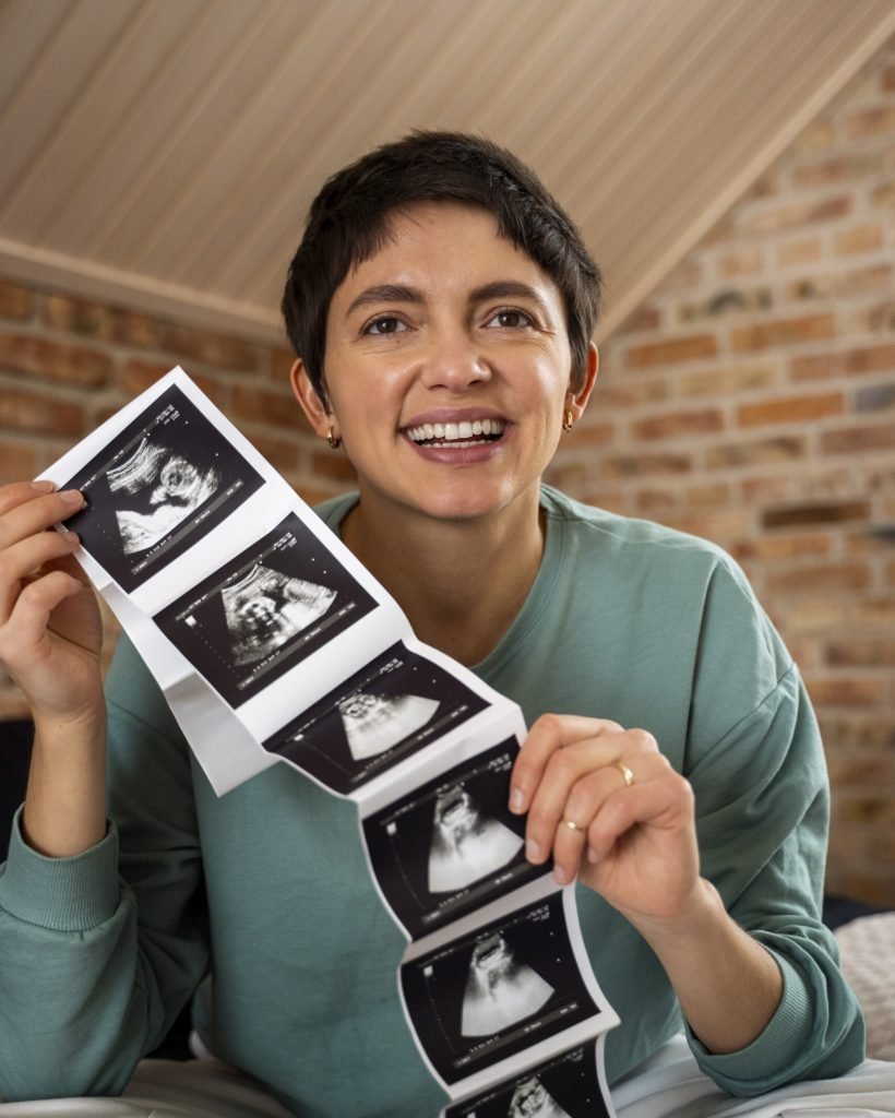 happy-woman-announcing-pregnancy-with-ultrasound